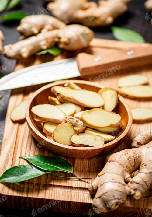 Preview: Chopped ginger on a cutting board with a knife.