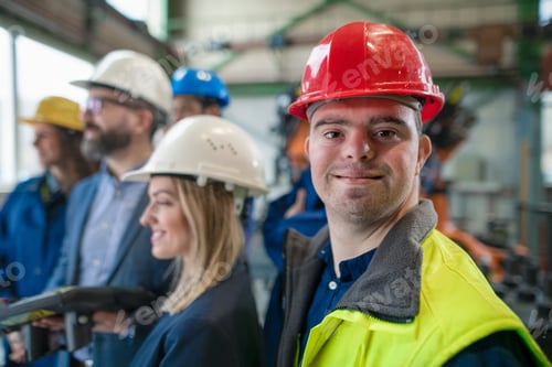 Preview: Young man worker with Down syndrome with manager and other collegues working in industrial factory