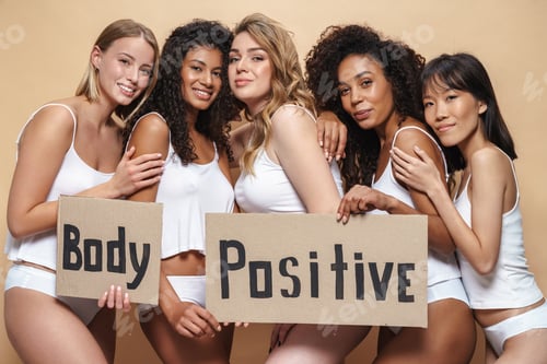 Preview: Image of cheerful multinational women hugging and holding placards