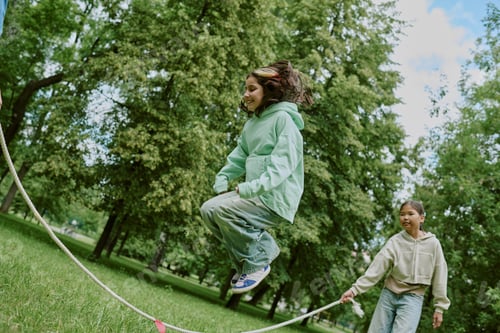 Preview: Multiethnic School Children Playing Jump Rope Outdoors