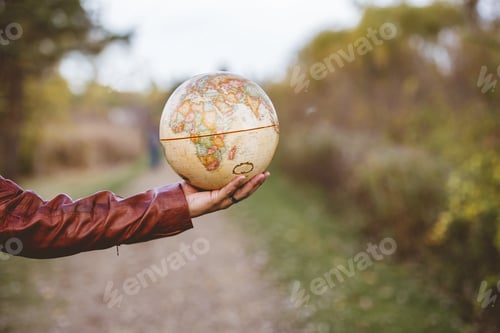 Preview: Closeup shot of a male holding a desk glove with a blurred background