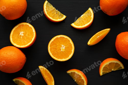 Preview: Raw Organic Orange Fruit on a black background, top view. Flat lay, overhead, from above.