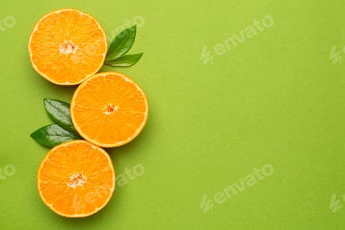 Preview: Tangerine on an green background, fruit flatlay, summer minimal compositon with copyspace