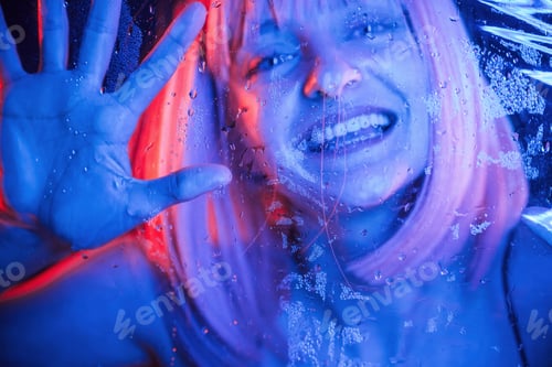Preview: positive facial expression. Stylish woman with white hair is behind wet transparent plastic sheet