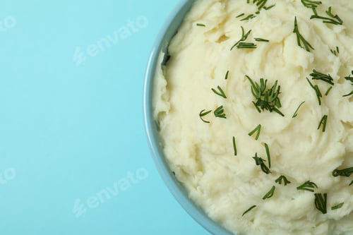 Preview: Plate of mashed potatoes on blue background