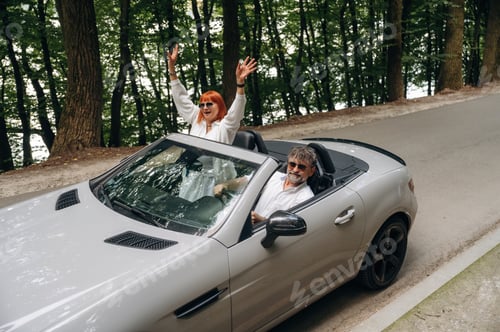 Preview: Vacation time. Senior couple driving convertible cabriolet car