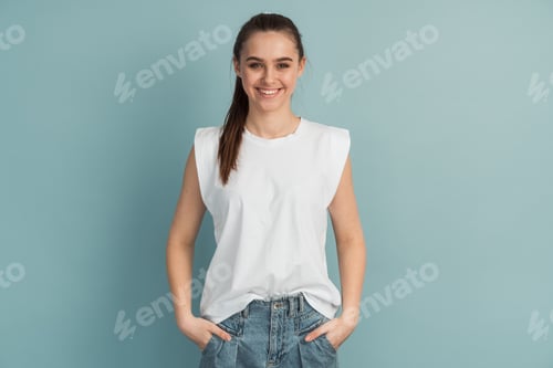Preview: Adorable, smiling, young girl in a white T-shirt on a blue background.