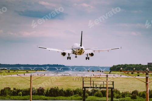 Preview: Closeup of an airplane flying over a field in the airport