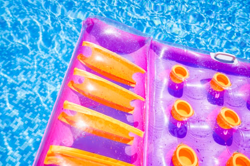 Preview: Inflatable floating mat in a pool in summer.