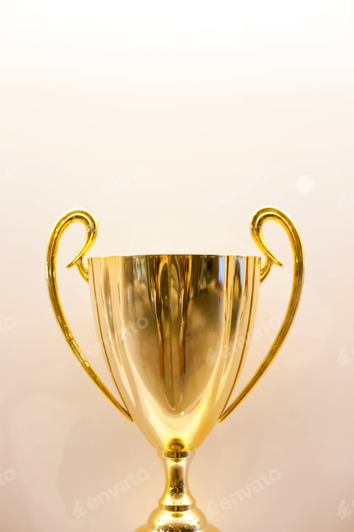 Preview: Golden winning trophy award on a shelf at hall of fame