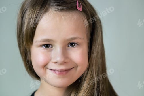 Preview: Close-up portrait of happy smiling little girl with long hair.