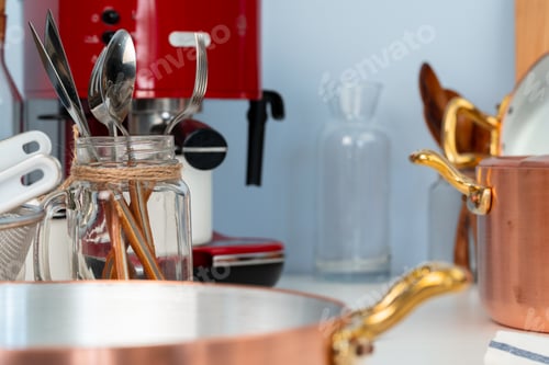 Preview: Clean cookware, utensils close up on table in modern kitchen