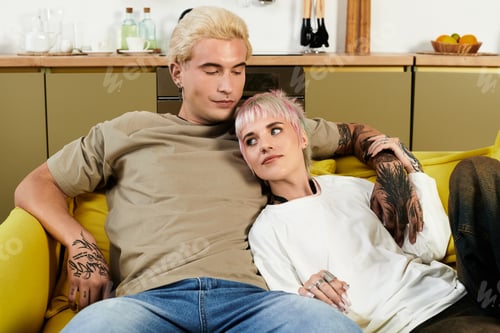 Preview: Young couple enjoying cozy moments together at home during a sunny afternoon