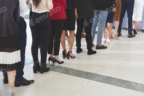 Preview: Low section of diverse business people checking in at conference registration table in office lobby