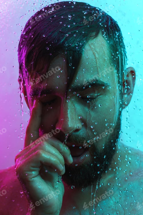 Preview: Portrait of handsome man under water flow in neon light