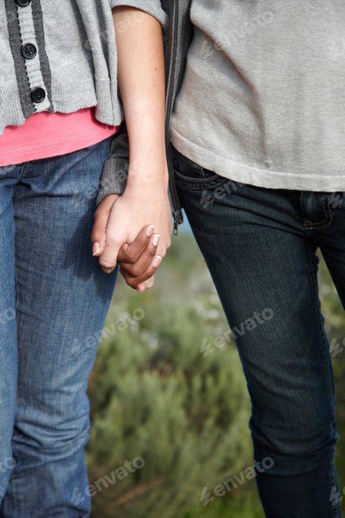 Preview: Two girls holding hands outdoors