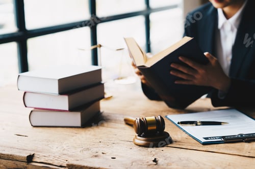 Preview: lawyer businessman working or reading law book in office workplace for consultant lawyer concept.