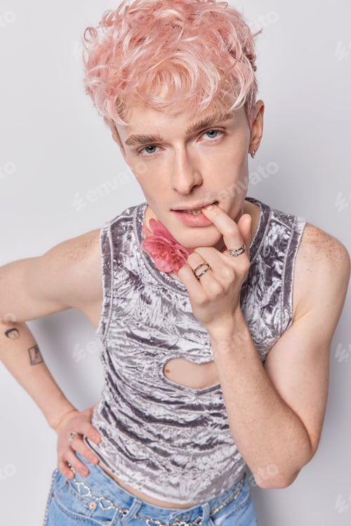 Preview: Vertical shot of seductive mysterious transgender man bites finger looks attentively at camera keeps