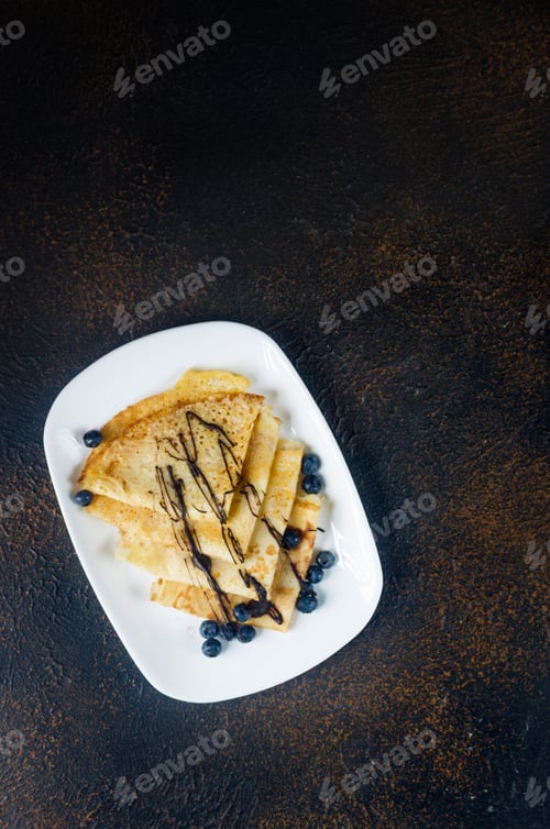 Preview: Thin homemade pancakes with berries, traditional Russian cuisine.