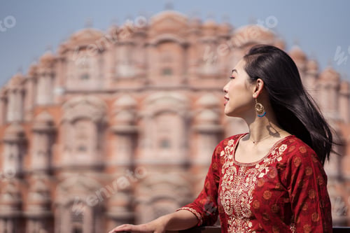 Preview: Asian tourist standing against oriental palace