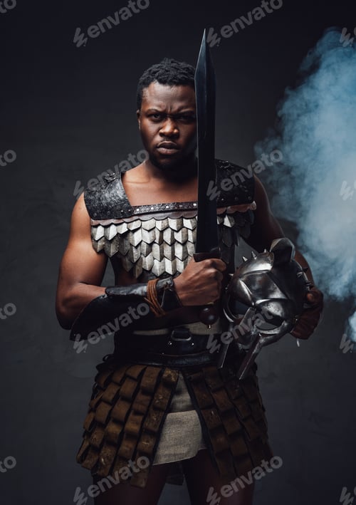 Preview: Studio shot of fearful authentic gladiator of african descent with gladius