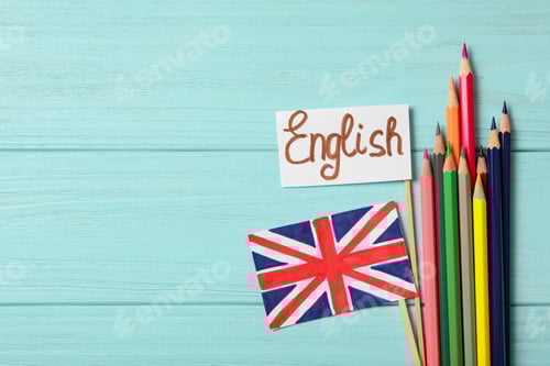 Preview: Word ENGLISH, UK flag and colorful pencils on light blue wooden background, flat lay. Space for text