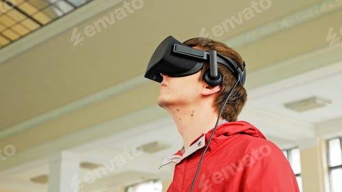 Preview: Teenager in VR headset playing virtual game