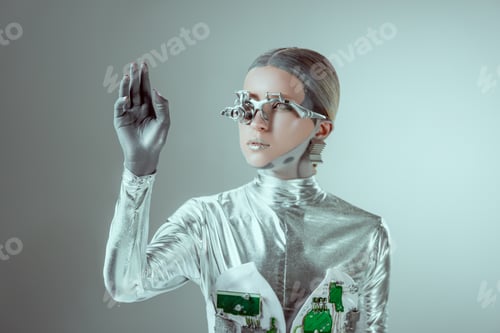 Preview: futuristic silver robot gesturing with hand and looking away isolated on grey, future technology