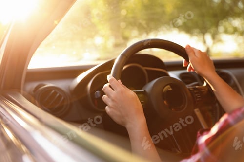 Preview: Woman behind steering wheel of modern car on sunny day, closeup