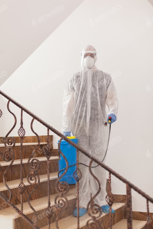 Preview: Disinfectant working in protective suit