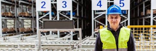 Preview: Storehouse employee in uniform working in modern automatic warehouse. Boxes are on the shelves