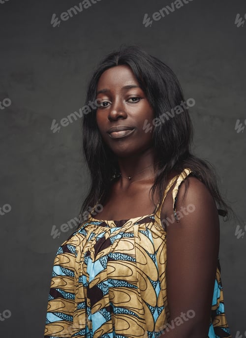 Preview: Black woman weared in dress against dark background