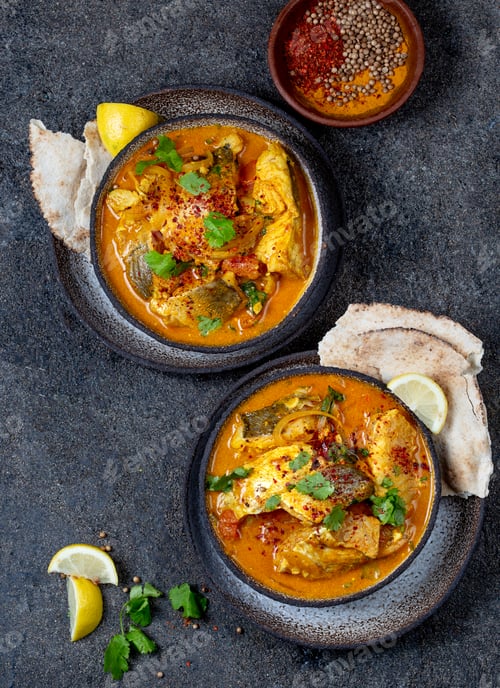 Preview: INDIAN FOOD. Traditional KERALA FISH CURRY with naan bread, gray plate, black background