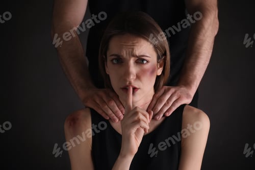 Preview: Man abusing scared woman on black background. Domestic violence