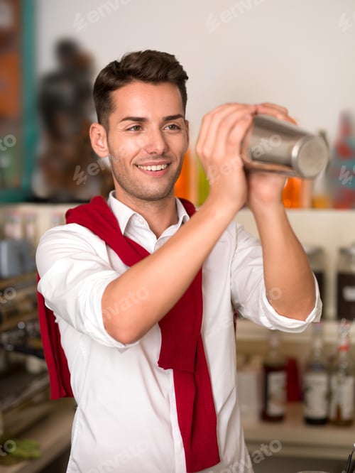 Preview: attractive bartender mixing a drink