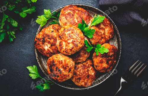 Preview: Homemade fried pork and beef meatballs in bowl, dark table background, top view