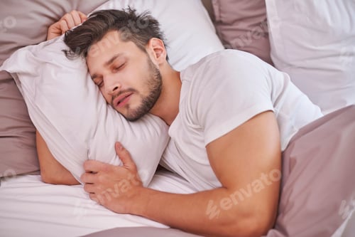 Preview: Exhausted man sleeping in his bed