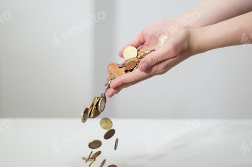Preview: Folded hands holding coins pouring out. Petty cash, money turnover. Cash Ban