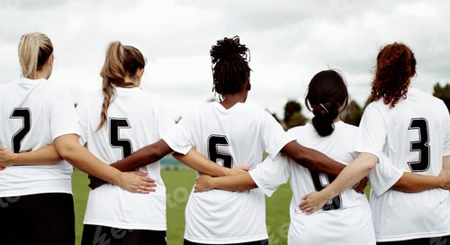 Preview: Female soccer players huddling and standing together