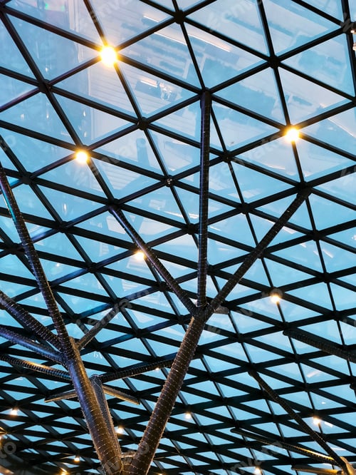 Preview: view of the metal structure of the glass roof at night with neon lights and lights