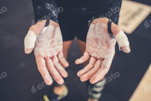 Preview: Close up of unrecognizable athlete indoors gym showing his hands prepared with chalk