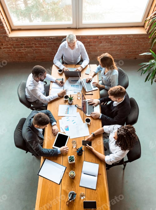 Preview: Diverse Coworkers Working Using Computers Sitting At Desk In Office