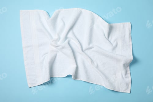 Preview: White crumpled towels on blue background, top viewWhite crumpled towels on blue background, top view