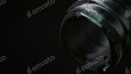 Preview: Closeup bottle neck drops falling down in super slow motion. Water droplets drip