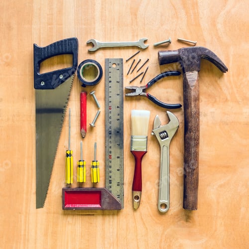 Preview: Set of different work tools on wooden table background.