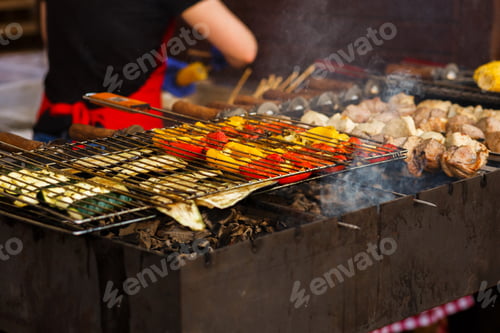 Preview: Delicious vegetables grilling on open grill, outdoor kitchen