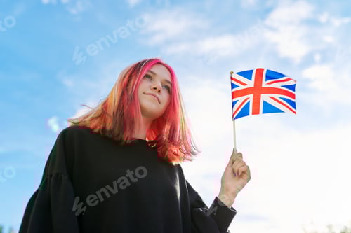 Preview: Female student teenager with British flag, blue sky with clouds background