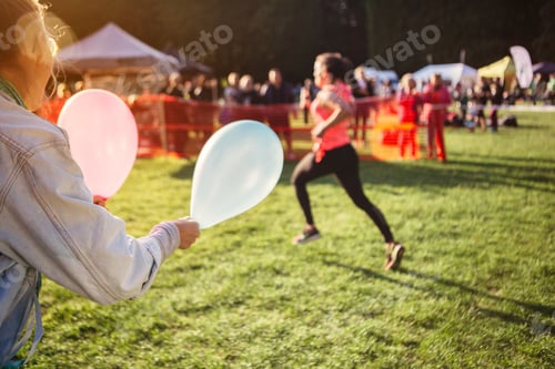 Preview: Supporter holding balloons at sports event