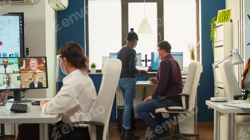 Preview: Business woman discussing on webcam using wireless headphone