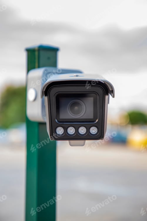 Preview: Front view of Security CCTV camera on a pylon with a blurred background